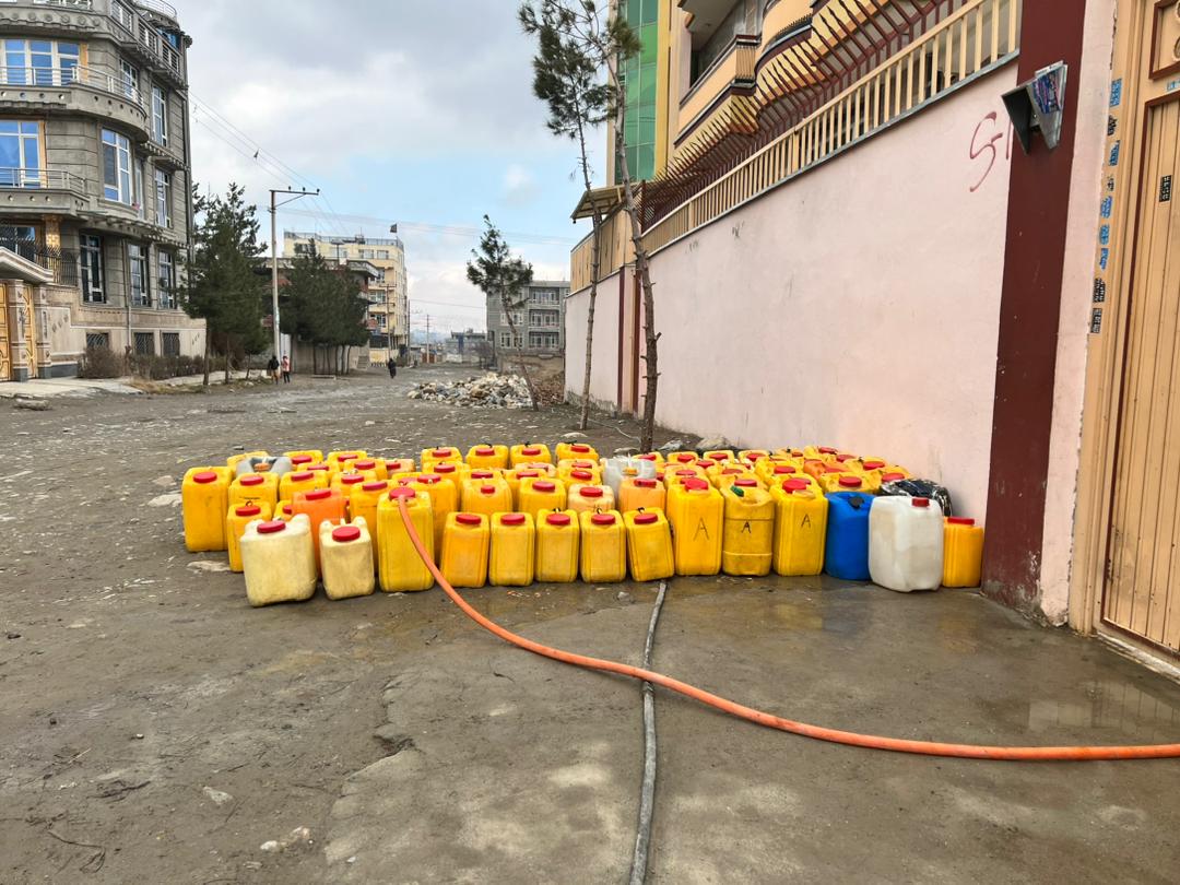 People left their barrels to get water from neighbors with deep wells in Kabul City, Afghanistan. Photo: Sayeda Rahimi/SAYWiW, March 2024.